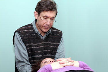 Dr Maryott examines a patient prior to making a chiropractic adjustment